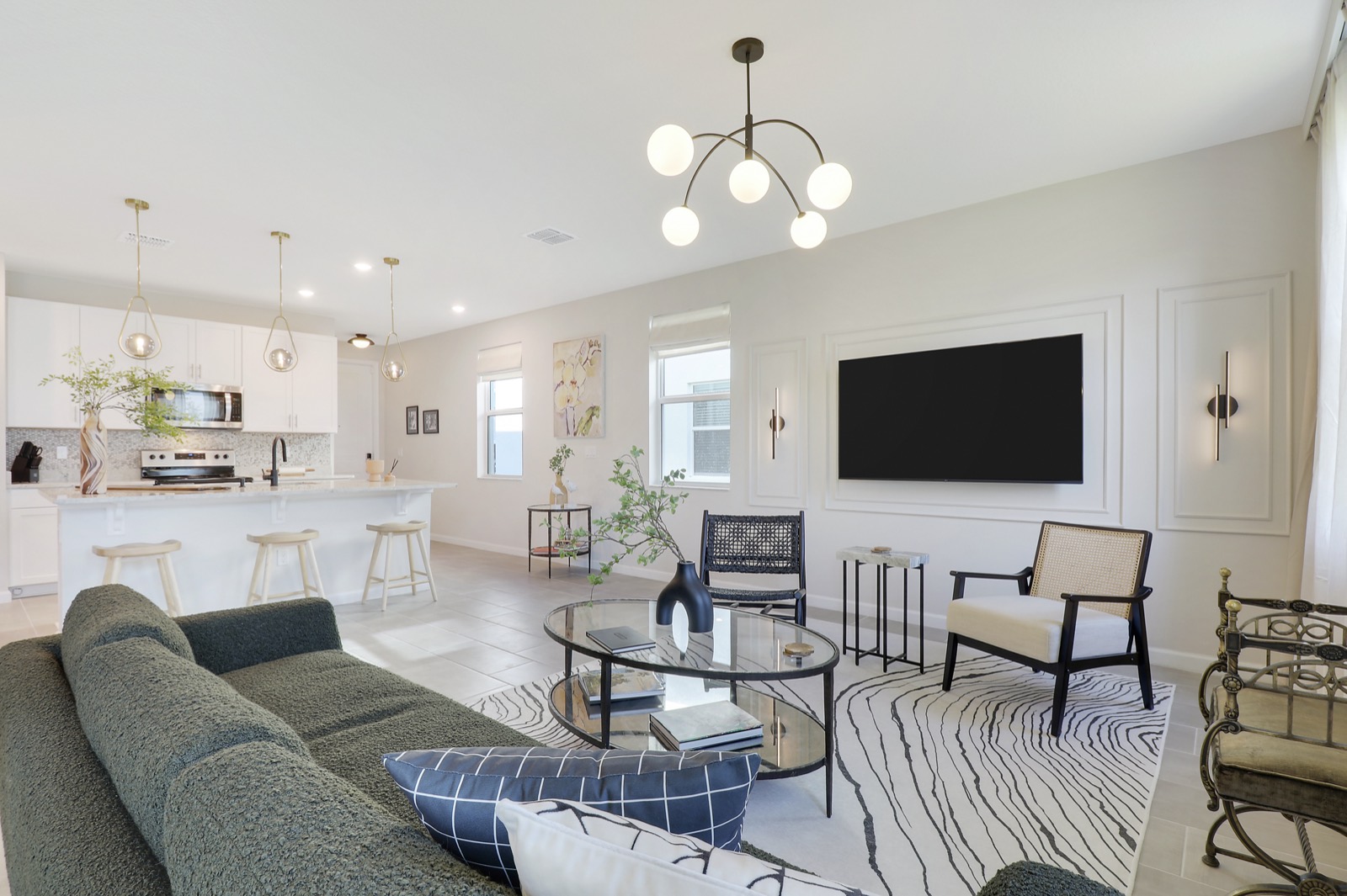 Living room TV wall with three picture-frame molding panels and a slim sconce on each side of the TV