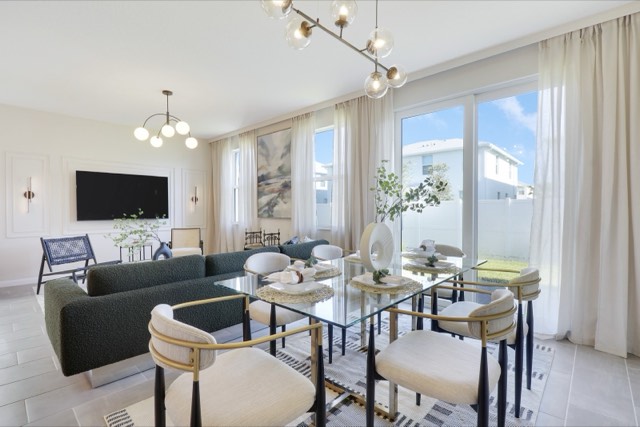 Living and dining room together, the glass table in front of the sliding doors and the sofa behind it