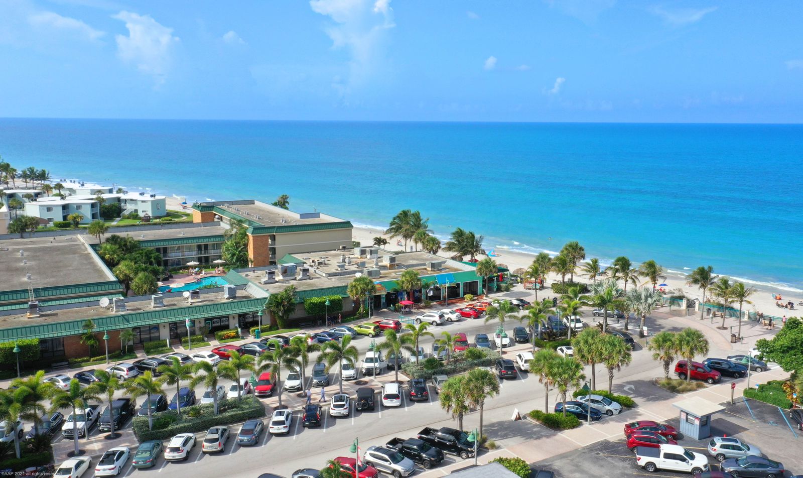 Aerial of Sexton Plaza on the oceanfront in Vero Beach, shops, parking and palms beside the beach