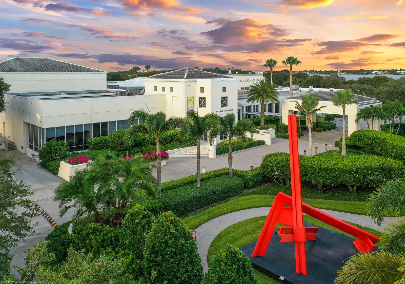 Vero Beach Museum of Art at sunset, a red sculpture in the landscaped sculpture garden in front